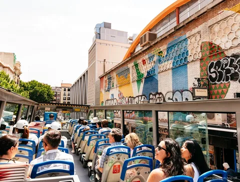 Madrid City Tour hop-on hop-off double-decker bus on a historic street